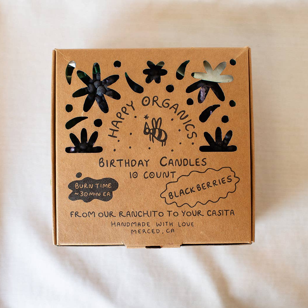 Happy Organics birthday candles box on a beige background