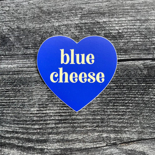 blue, heart-shaped sticker with text in center that says "blue cheese"