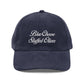 Blue corduroy cap with 'Blue Cheese Stuffed Olives' text on a white background