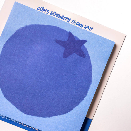 Blueberry-shaped sticky note pad with blueberry illustration on a white background