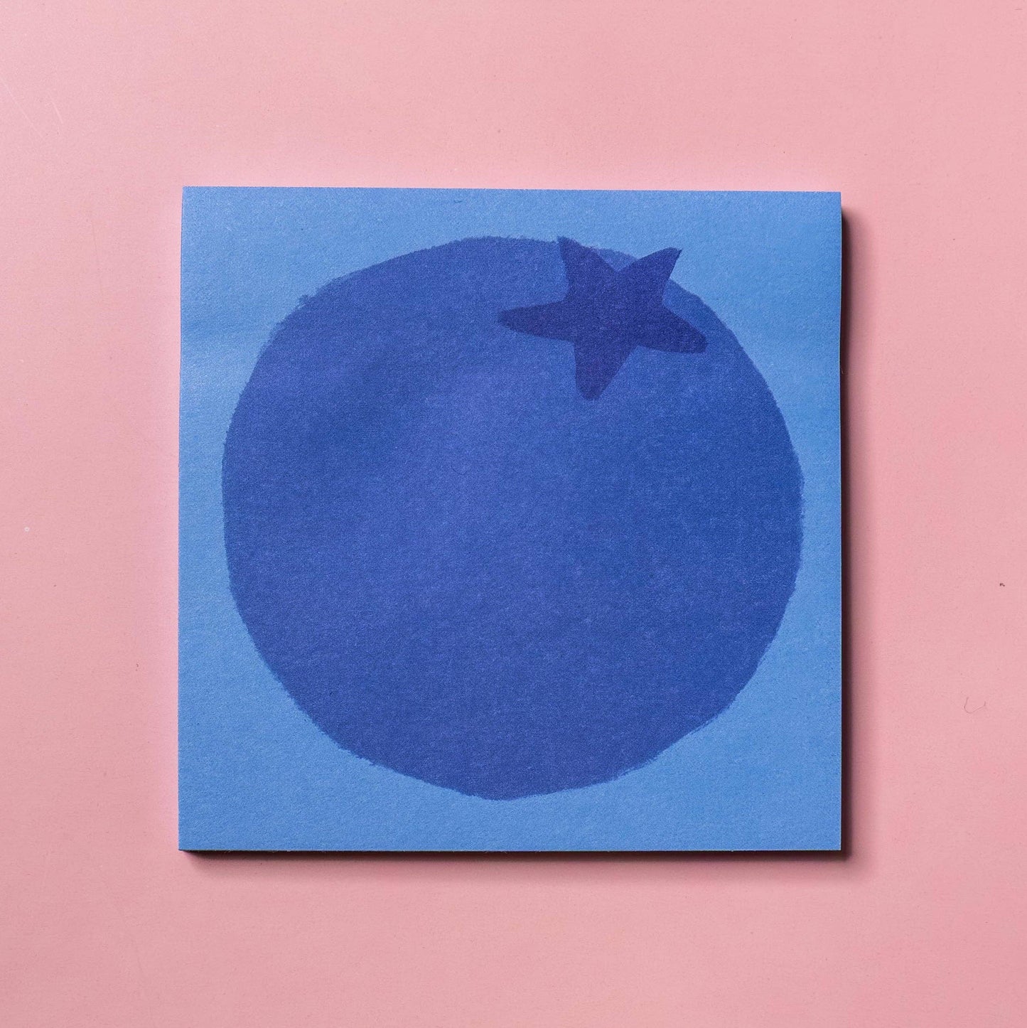 Blueberry designed sticky notes on a pink background