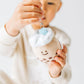 Boba plush keychain with a teal colored straw being held by a child