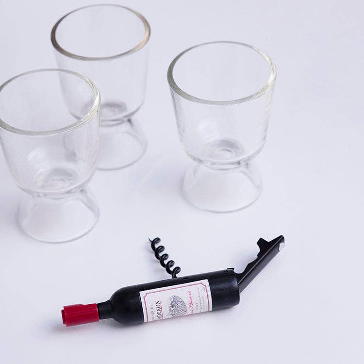 Wine bottle shaped corkscrew, three empty wine glasses on a white background