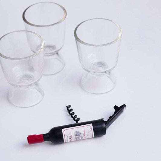 Wine bottle shaped corkscrew, three empty wine glasses on a white background