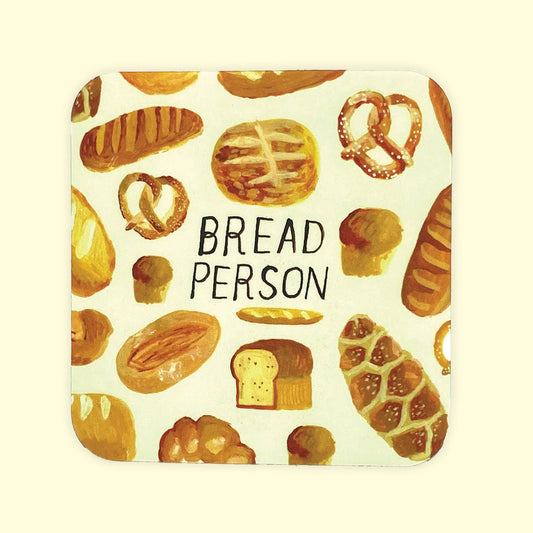 A square coaster with rounded corners featuring a watercolor-style pattern of various breads, loaves, pretzels, and a slice of bread on an off-white background, with the words 'BREAD PERSON' printed in black in the center.