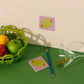 new design of the original olive sticky notes, this time in a brighter colorway. Pink background with a stuffed green olive