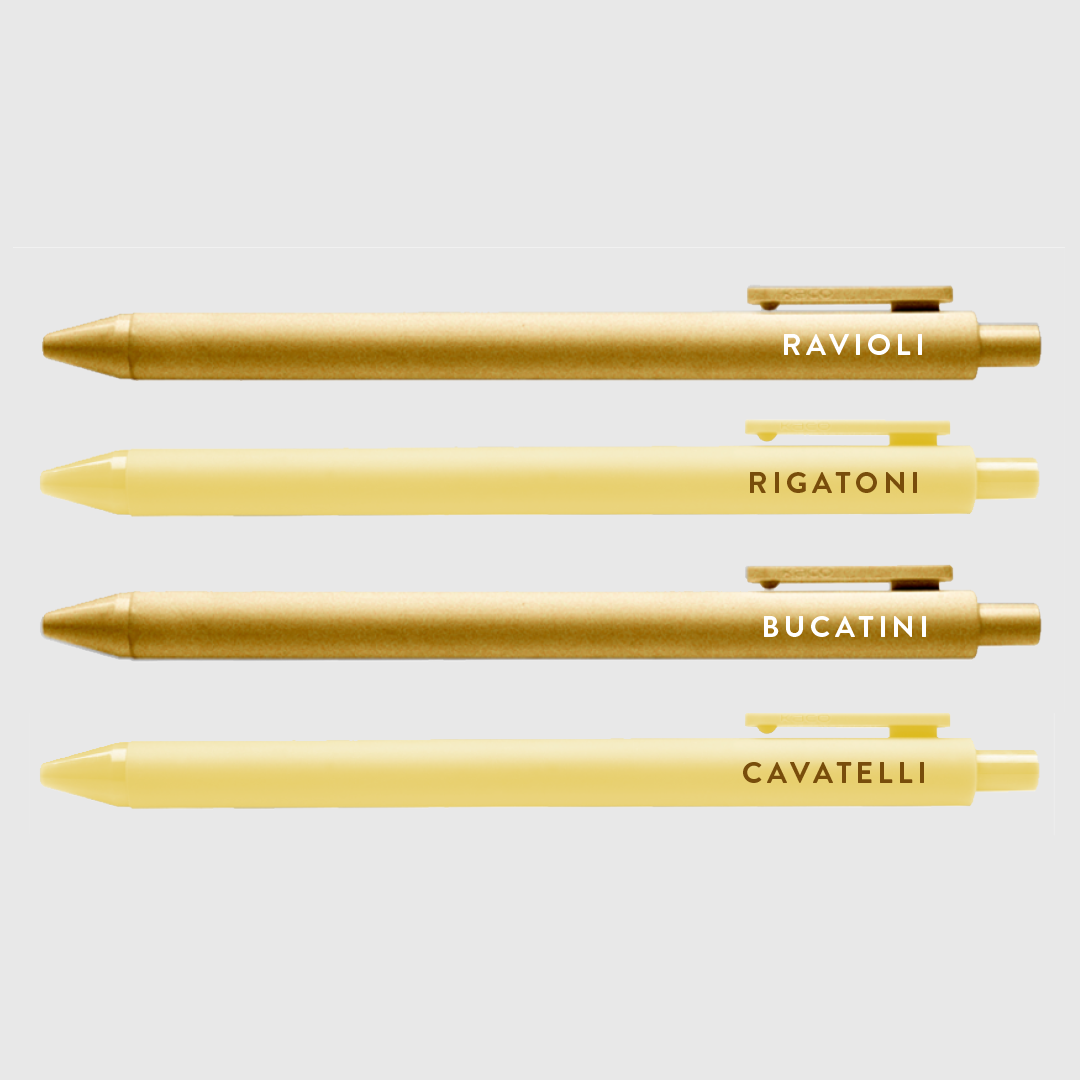 Set of 4 pasta pen set with text -- pen barrels are either gold or light yellow. Text on gold pens read "ravioli" and "bucatini", text on light yellow read "rigatoni" and "cavatelli" 