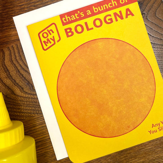 Greeting card with 'Oh my that's a bunch of bologna" text on a wooden surface with a mustard bottle