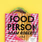 Burger bookmark sticking out of a book titled "Food Person" by Adam Roberts 