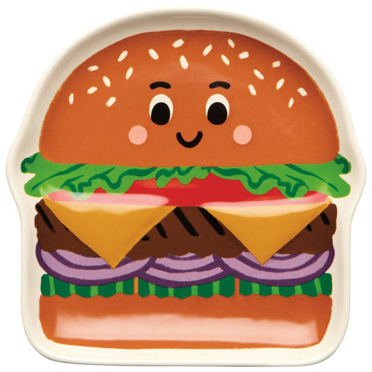 plate shaped like a cartoon hamburger with a smiling face on a white background
