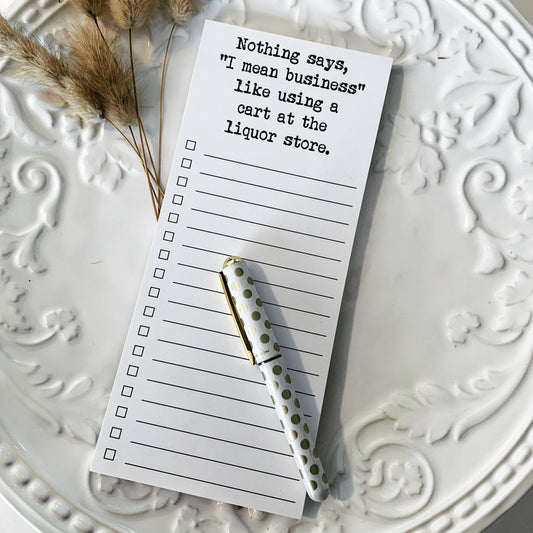 Liquor store list notepad on white platter with a pen 