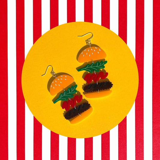 Stacked burger earrings with fish hook backings. Buns, patty, ketchup, lettuce