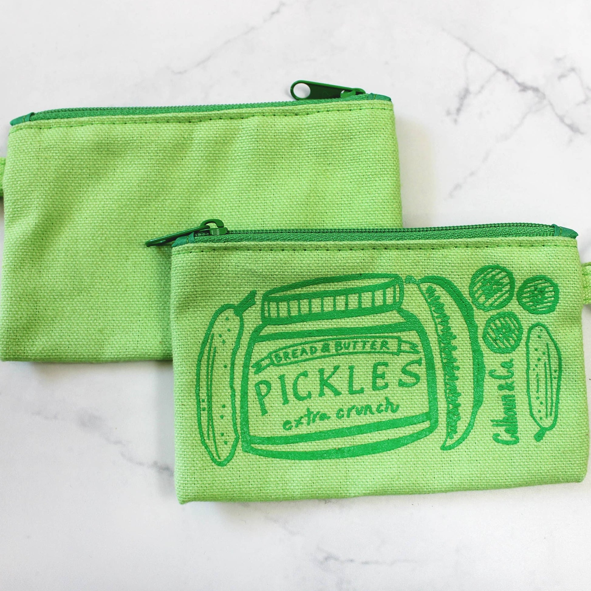 Showcasing back and front of green zippered pickle pouch