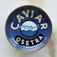 Caviar Osetra logo on a blue and gold trinket dish with a marble background