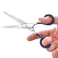 Photo of scissors being held open in someone's hand.