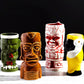 Four colorful tiki mugs with unique designs on a black background