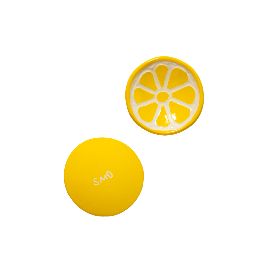 top and bottom of lemon slice shaped trinket tray on a white background