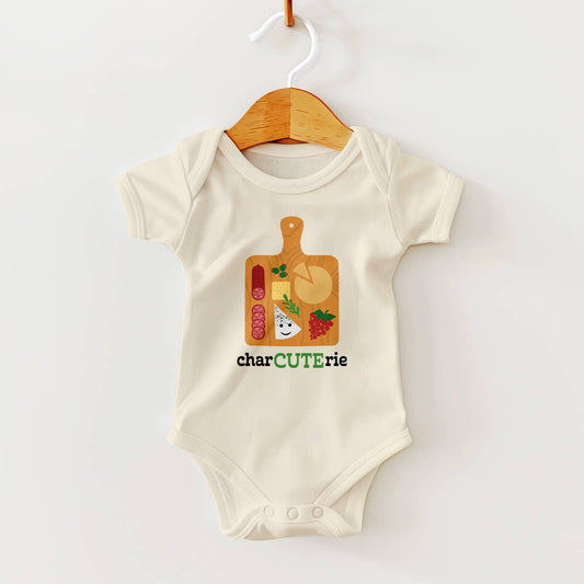 Baby onesie with charcuterie design on a hanger against a white background