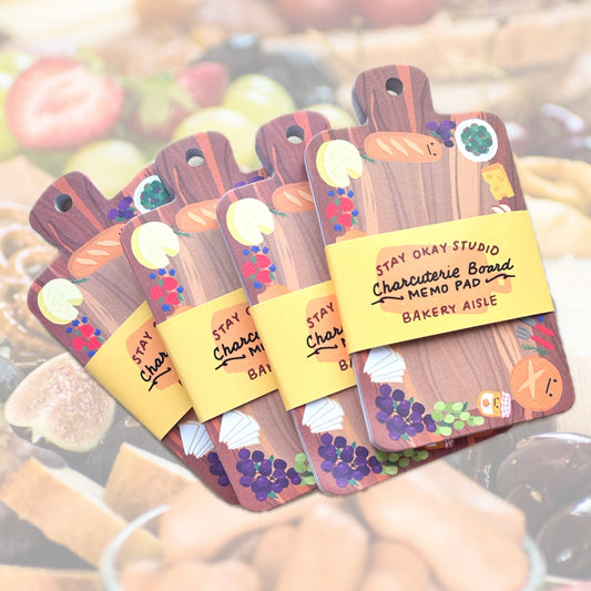 Set of charcuterie board-themed memo pads with a blurred background