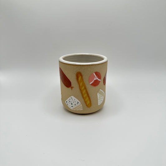 Cheese & Charcuterie Tumbler has an assortment of cheeses, meats and baguettes in various shapes, sizes and cuts.