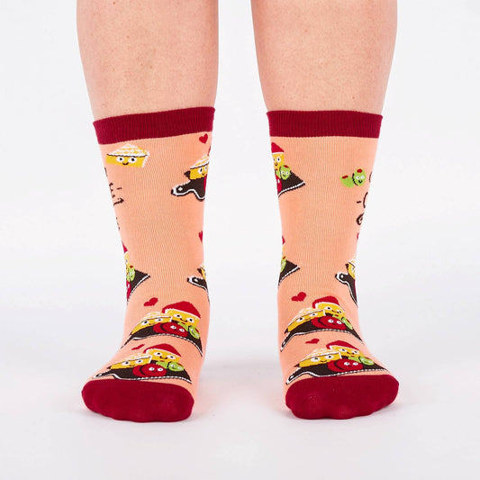 Pair of pink and burgundy socks with cartoon illustration of a charcuterie board design and text (char-CUTE-erie) on a white background