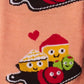 Up close detail of pair of pink and burgundy socks with cartoon illustration of a charcuterie board design and text (char-CUTE-erie) on a white background