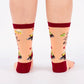 Pair of pink and burgundy socks with cartoon illustration of a charcuterie board design and text (char-CUTE-erie) on a white background