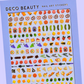 Sheet of Deco Beauty nail art stickers with various charcuterie-themed designs on a blue background.