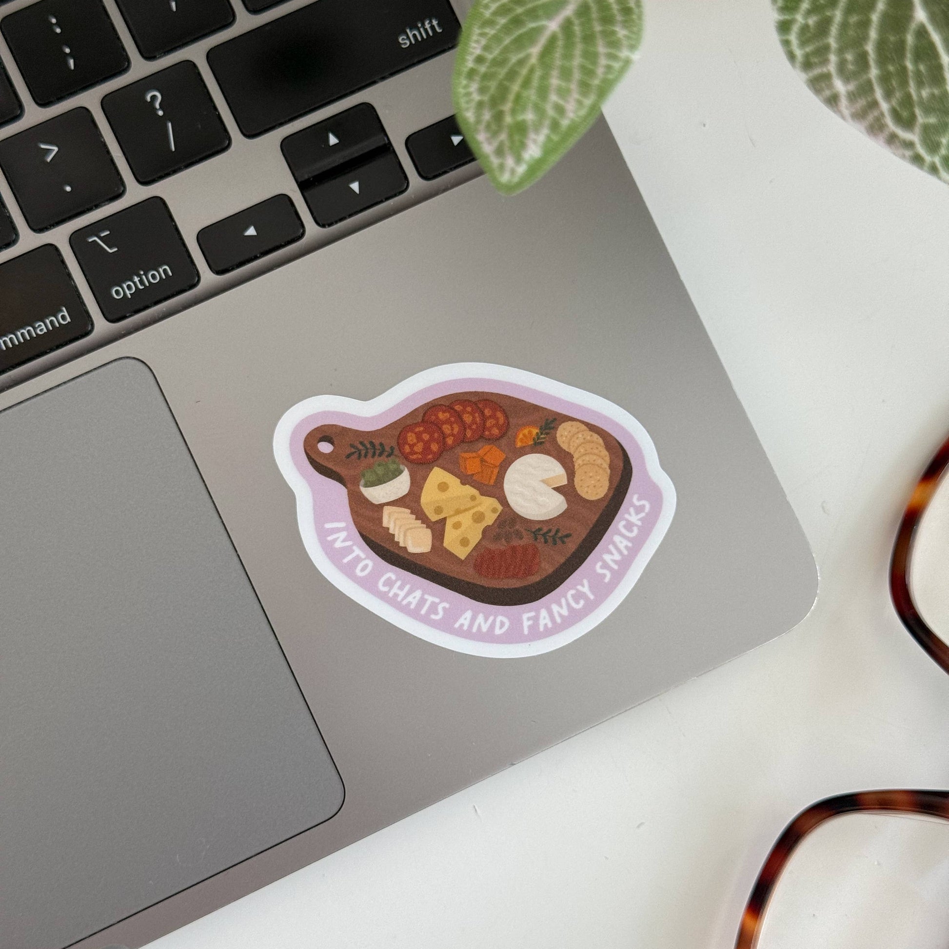 charcuterie board sticker with text "into chats and fancy snacks" 