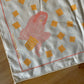 Fabric with a printed design of a woman and cheez it shapes on a wooden surface