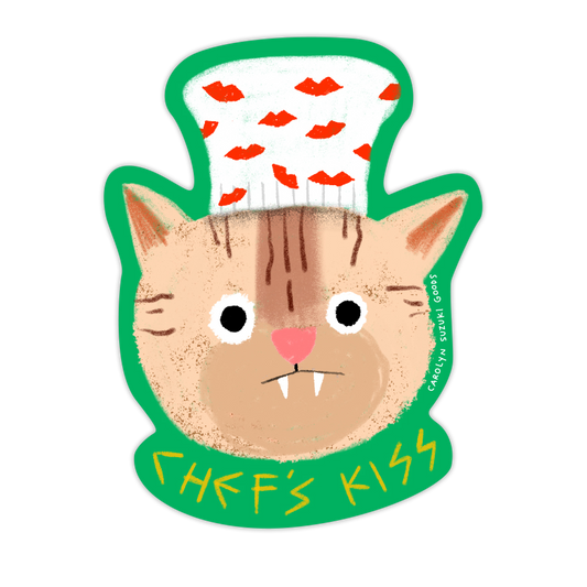 sticker of a cat with fangs wearing a white chef's hat with red lips on it and text at the bottom that reads "Chef's Kiss" 