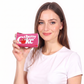A woman holding a small pink zippered pouch with the 'cherry Coke' logo, shown against a plain white background.