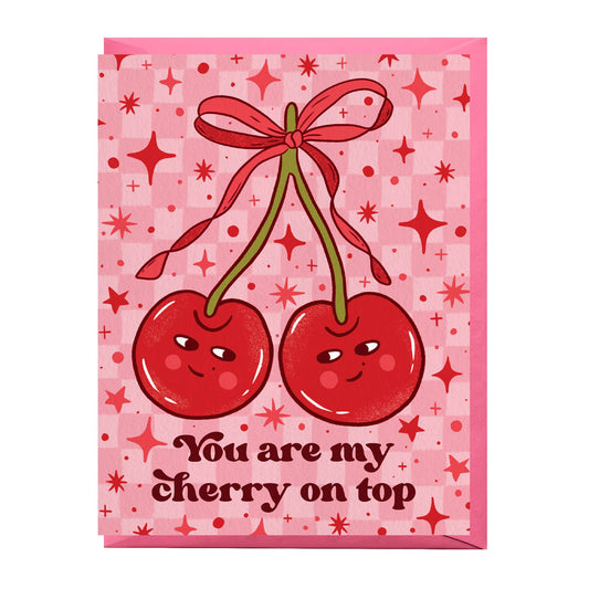 Greeting card with cherries and text 'You are my cherry on top' on a pink background