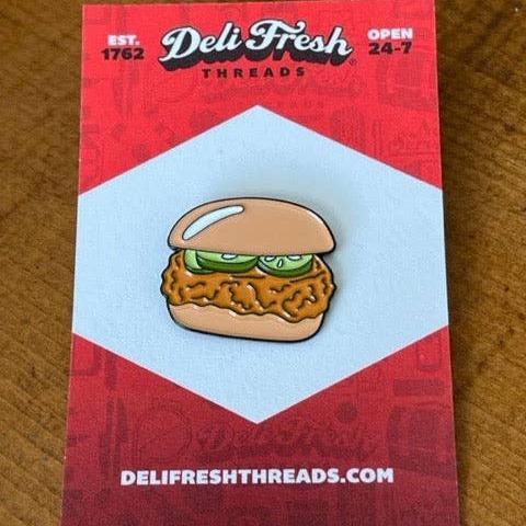 Chicken sandwich lapel pin with 3 pickles on a card backing that says Deli Fresh