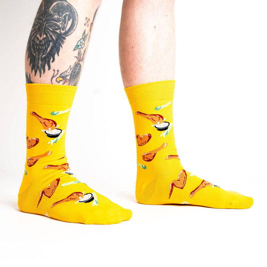 bright yellow socks with fried chicken wings, celery sticks and bleu cheese all over it 