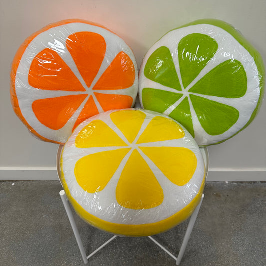 Three citrus fruit pillows- orange, lemon and lime.