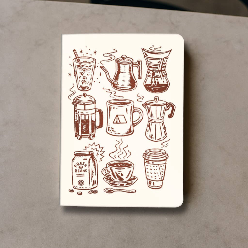 Notebook with coffee-themed illustrations on a gray surface