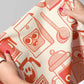 Person holding a kitchen towel with red coffee-themed patterns on a white background