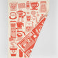 Tea towel with red coffee-themed illustrations on a white background