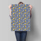 Person holding a large sheet of paper with a beer-themed pattern against a gray background
