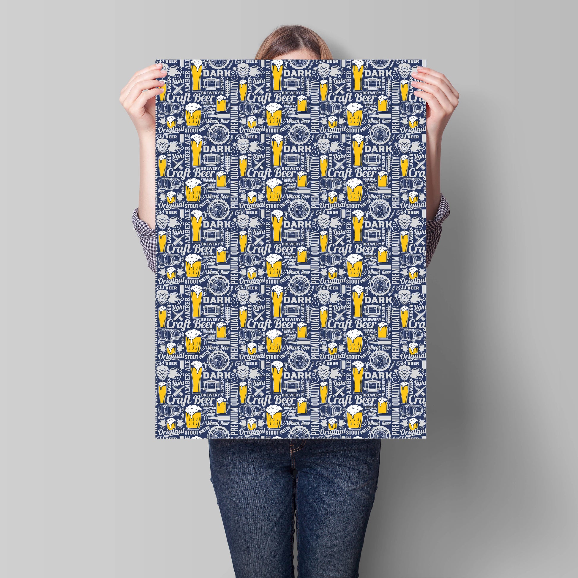 Person holding a large sheet of paper with a beer-themed pattern against a gray background
