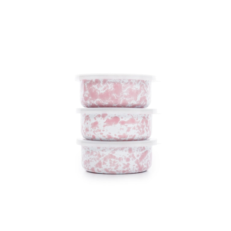 Stack of 3 enamel storage bowls with lids. Pink splatter pattern throughout. 