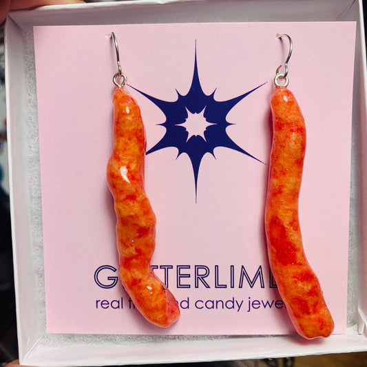 Hot cheetos earrings on card backing 