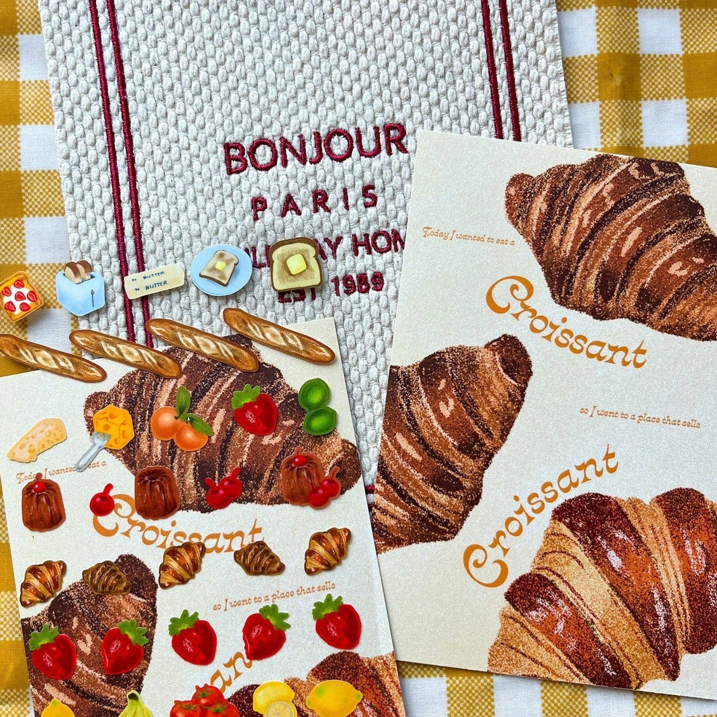 Fruit and bread sticker sheet next to the croissant post card 