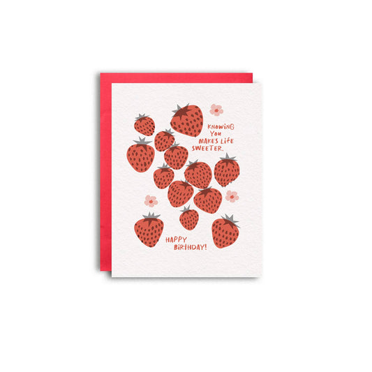 Greeting card -- mostly white with red strawberries and pink flowers all over. text reads "Knowing you makes life sweeter. Happy birthday!" 
