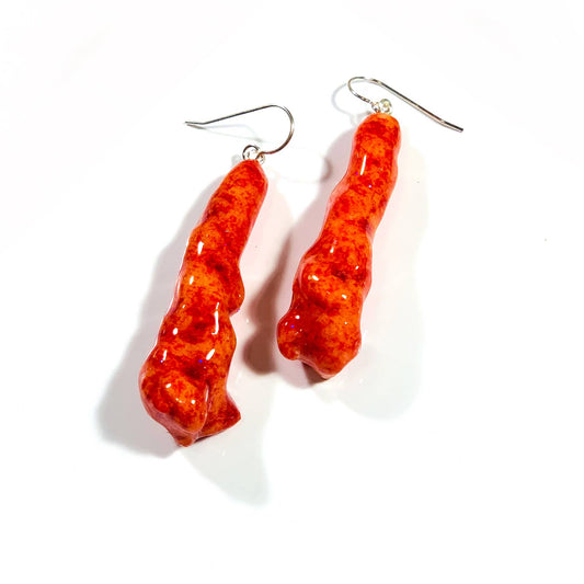 Hot cheetos coated in resin, with attached hook earring backings 
