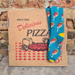 image of the deep dish pizza socks laying on a brown pizza box