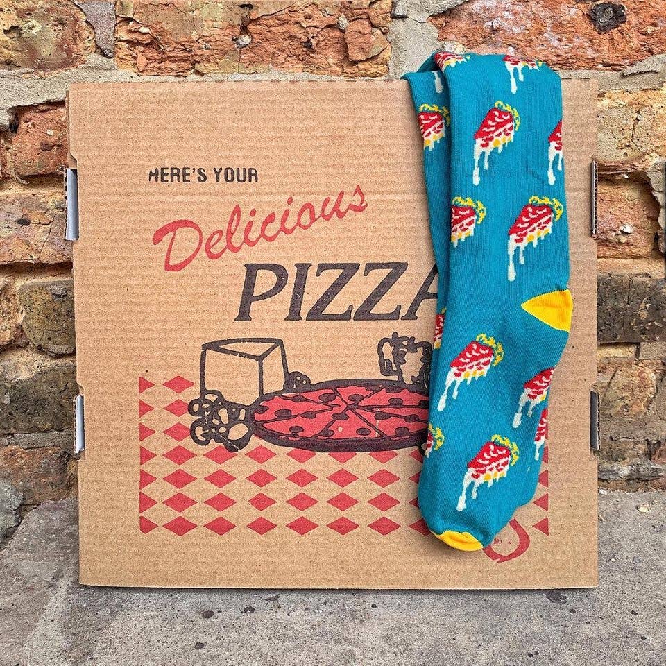 image of the deep dish pizza socks laying on a brown pizza box