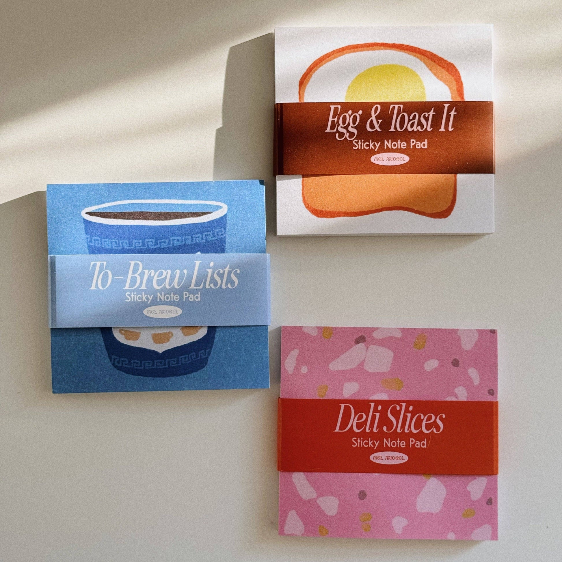 two new sticky note designs -- deli slices and to-brew lists -- pictured here with an original, egg & toast it notes 