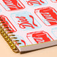 Notebook with Diet Coke can pattern on a beige background